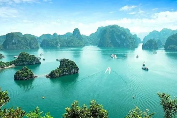 Scenic view of emerald waters with limestone islands and boats in Ha Long Bay, Vietnam